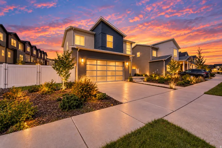 Modern exterior with mixed material siding and a glass-paneled garage door