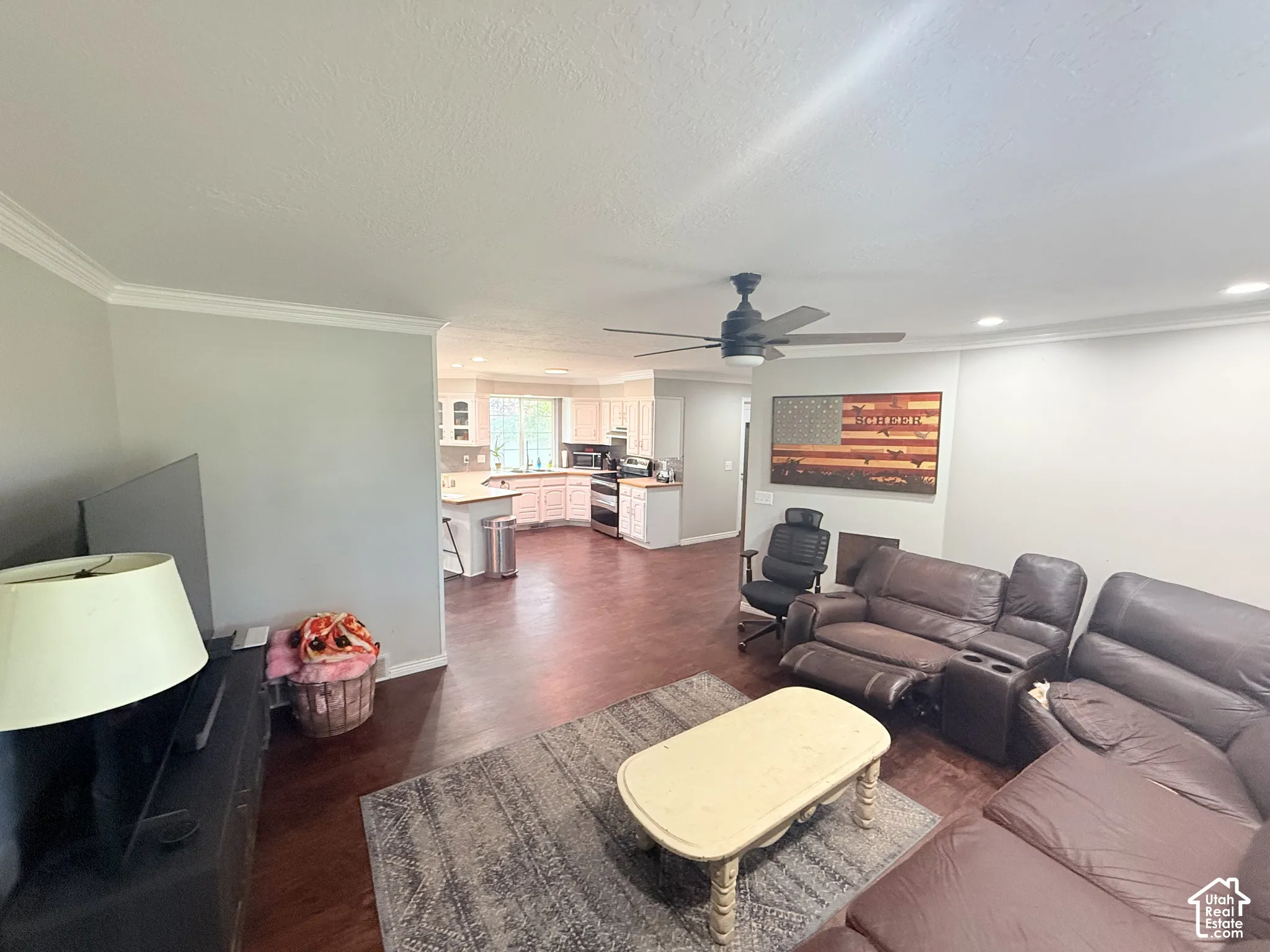 Wood-finish flooring throughout, crown molding, ceiling fan, and recessed lighting