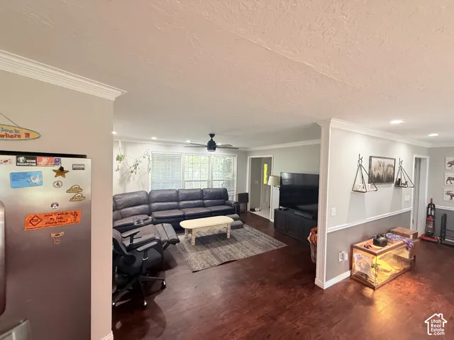 Hardwood-finish flooring, recessed lighting, crown molding, and an integrated ceiling fan