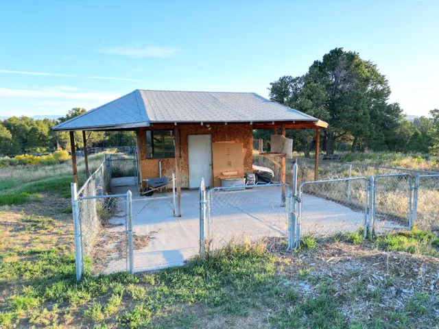 Small structure with a pitched roof, exterior wood siding, and an attached covered porch