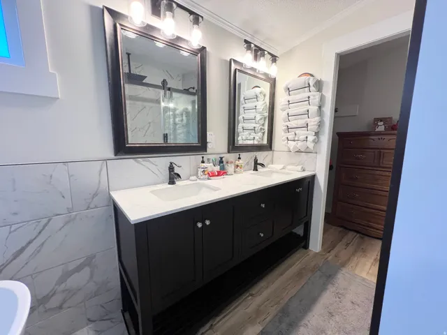 Dual-sink vanity with a white countertop and dark cabinetry