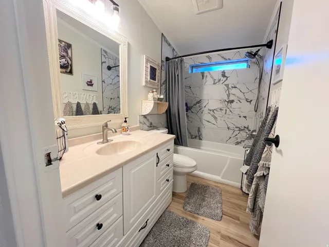 White vanity with panel-front cabinetry and a built-in sink