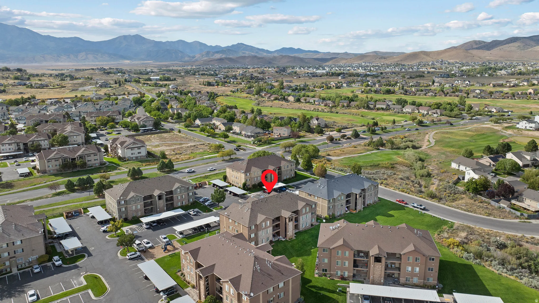 Residential community featuring multi-story buildings with covered parking structures
