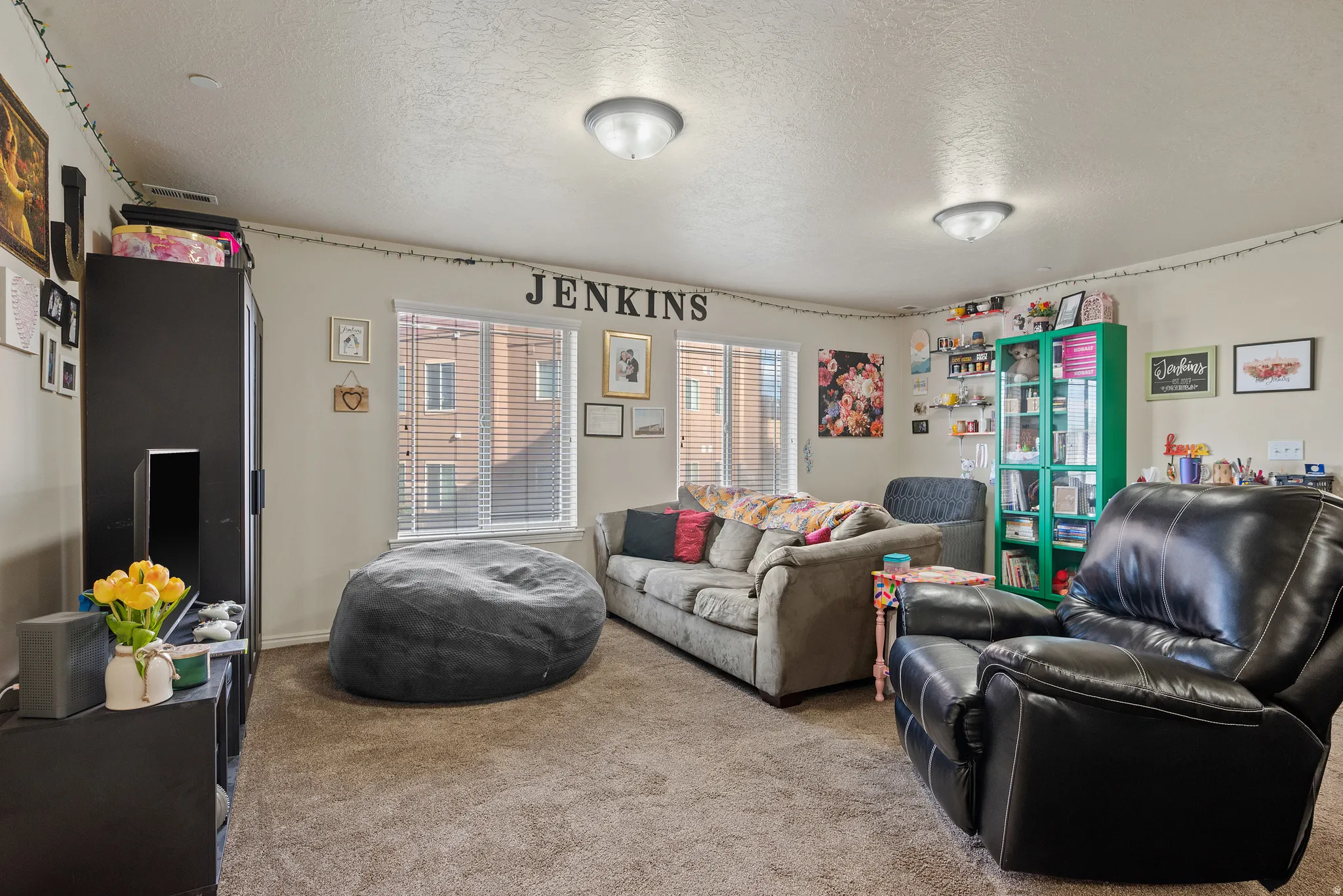 Dual windows with horizontal blinds, providing ample natural light