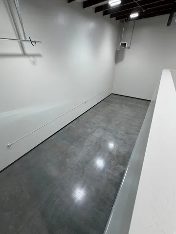Polished concrete flooring with high ceilings and exposed beams