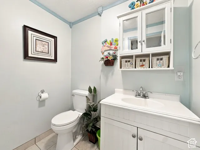 White vanity with an integrated sink and chrome faucet, accompanied by a matching wall-mounted storage cabinet