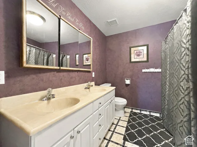 Dual vanity with integrated sinks, framed medicine cabinet, and tiled flooring