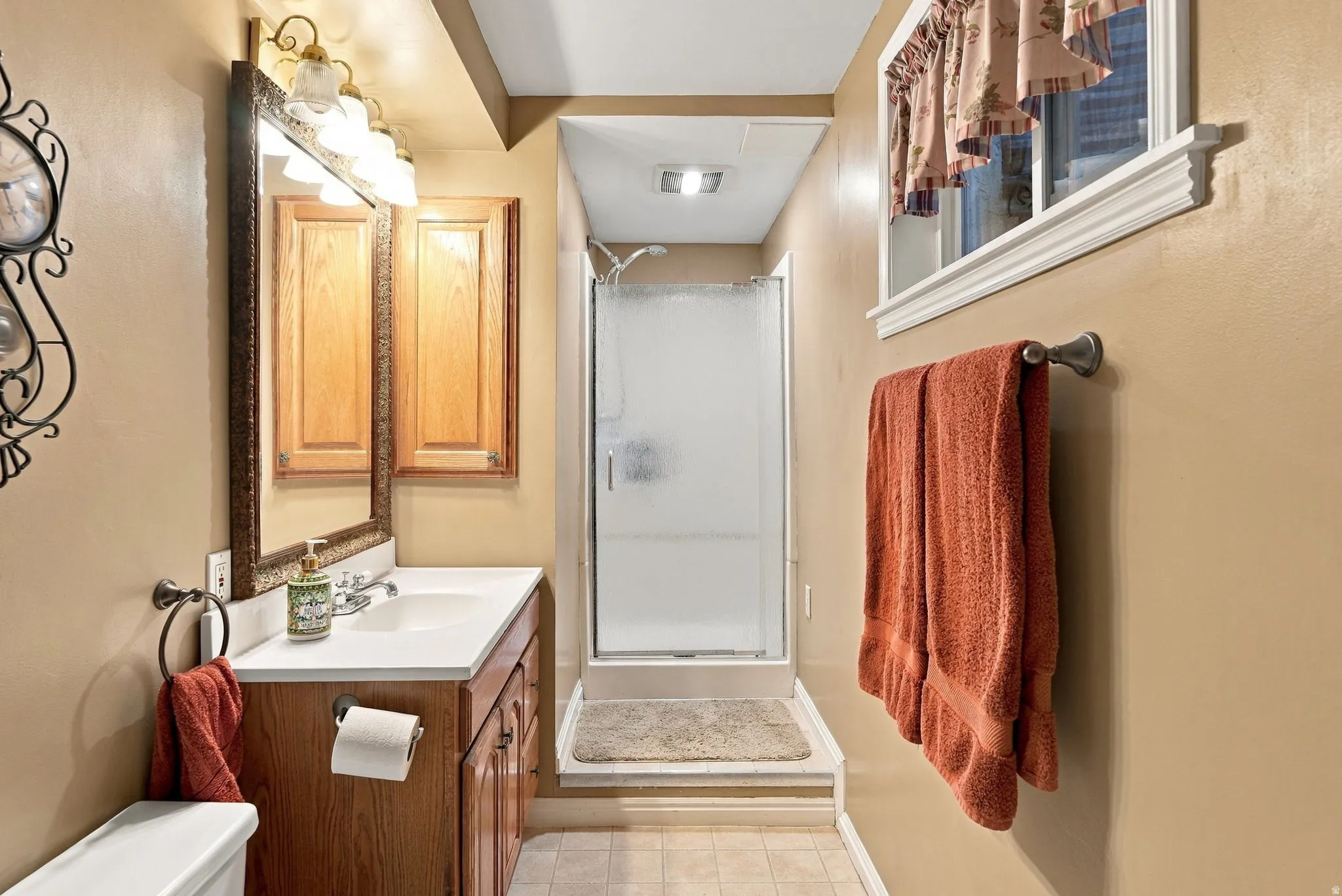 Wood-finish vanity with an integrated sink and base cabinetry