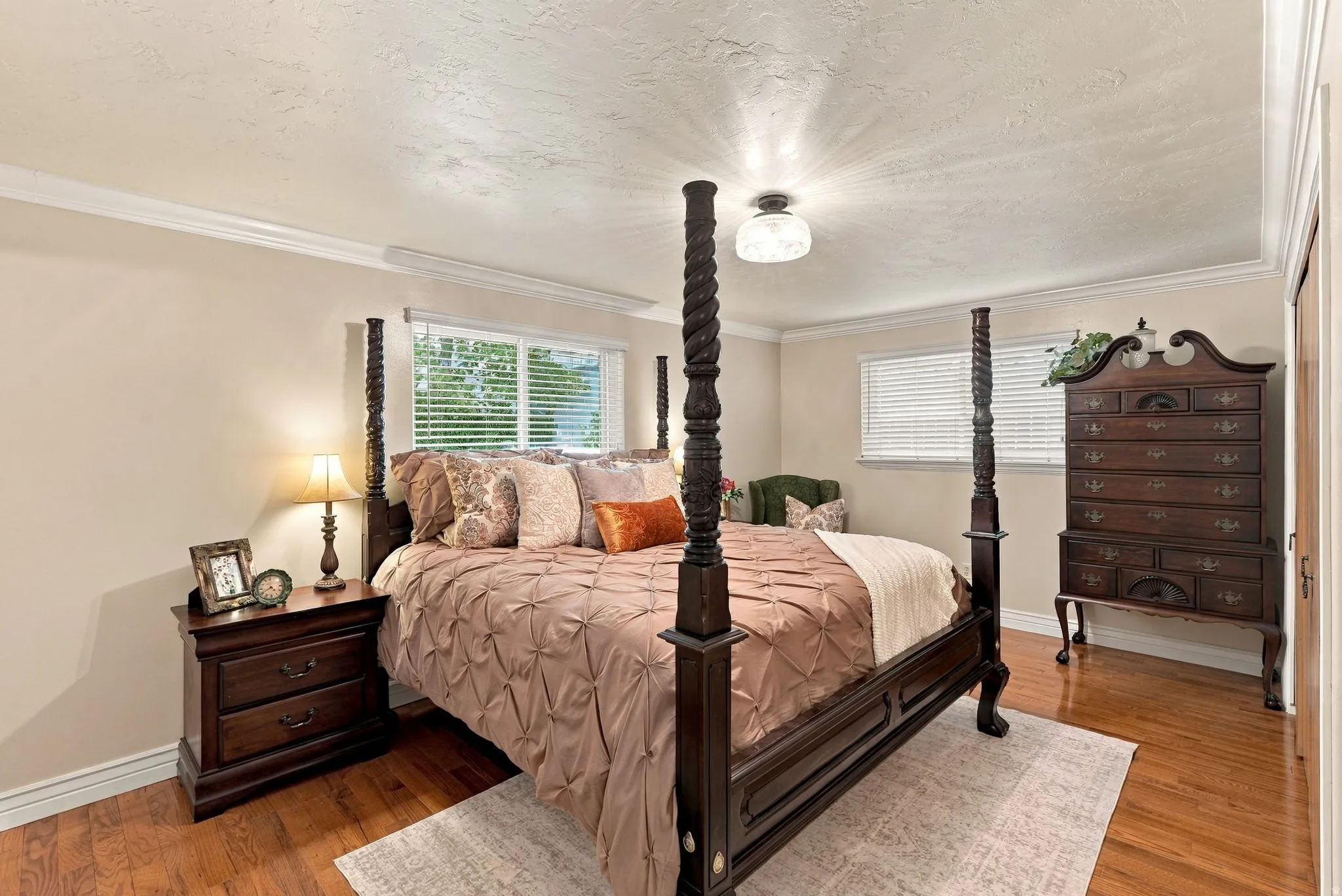 Wood-finish flooring, crown molding, and neutral wall tones