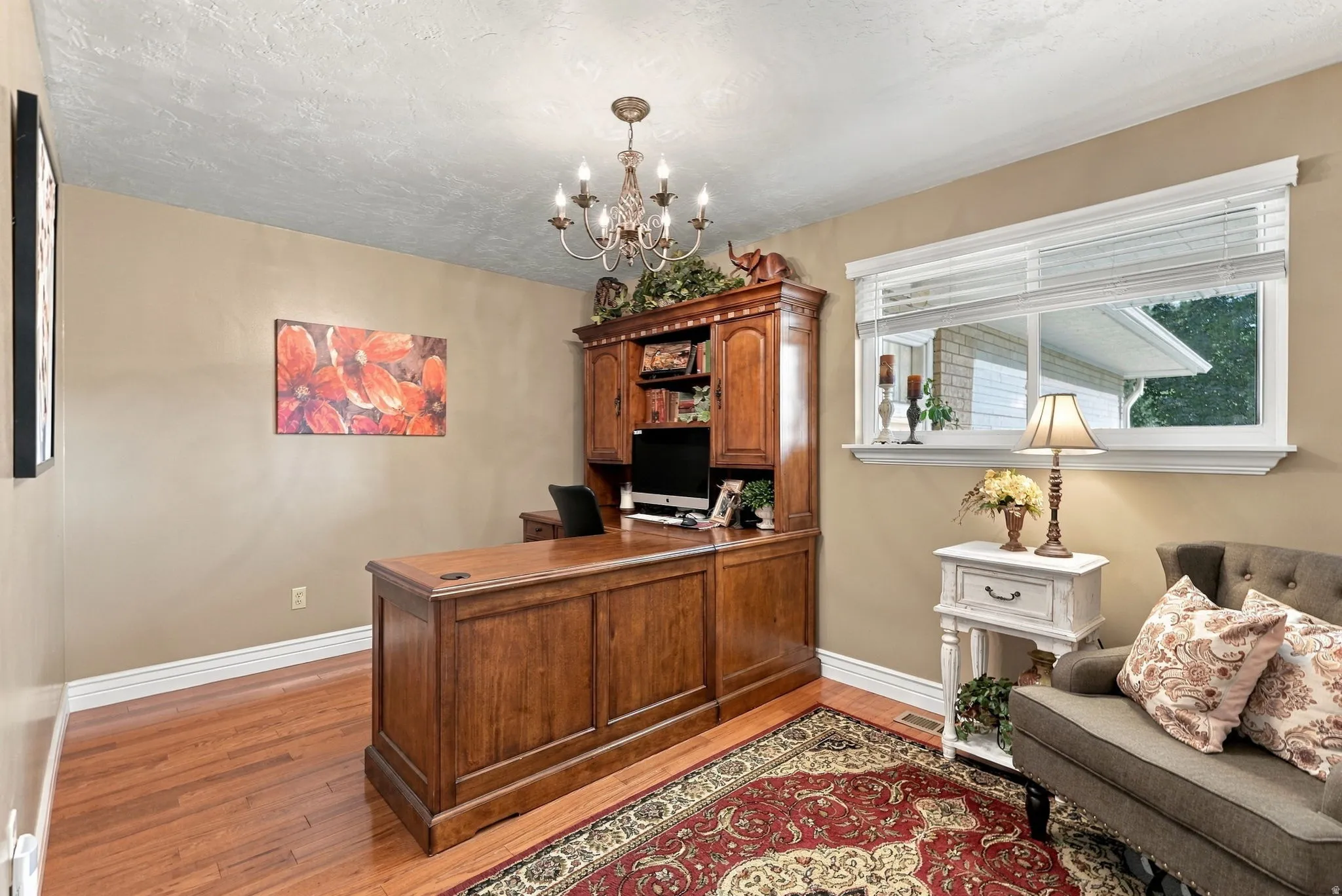Hardwood flooring, crown molding, white window trim, and a chandelier lighting fixture