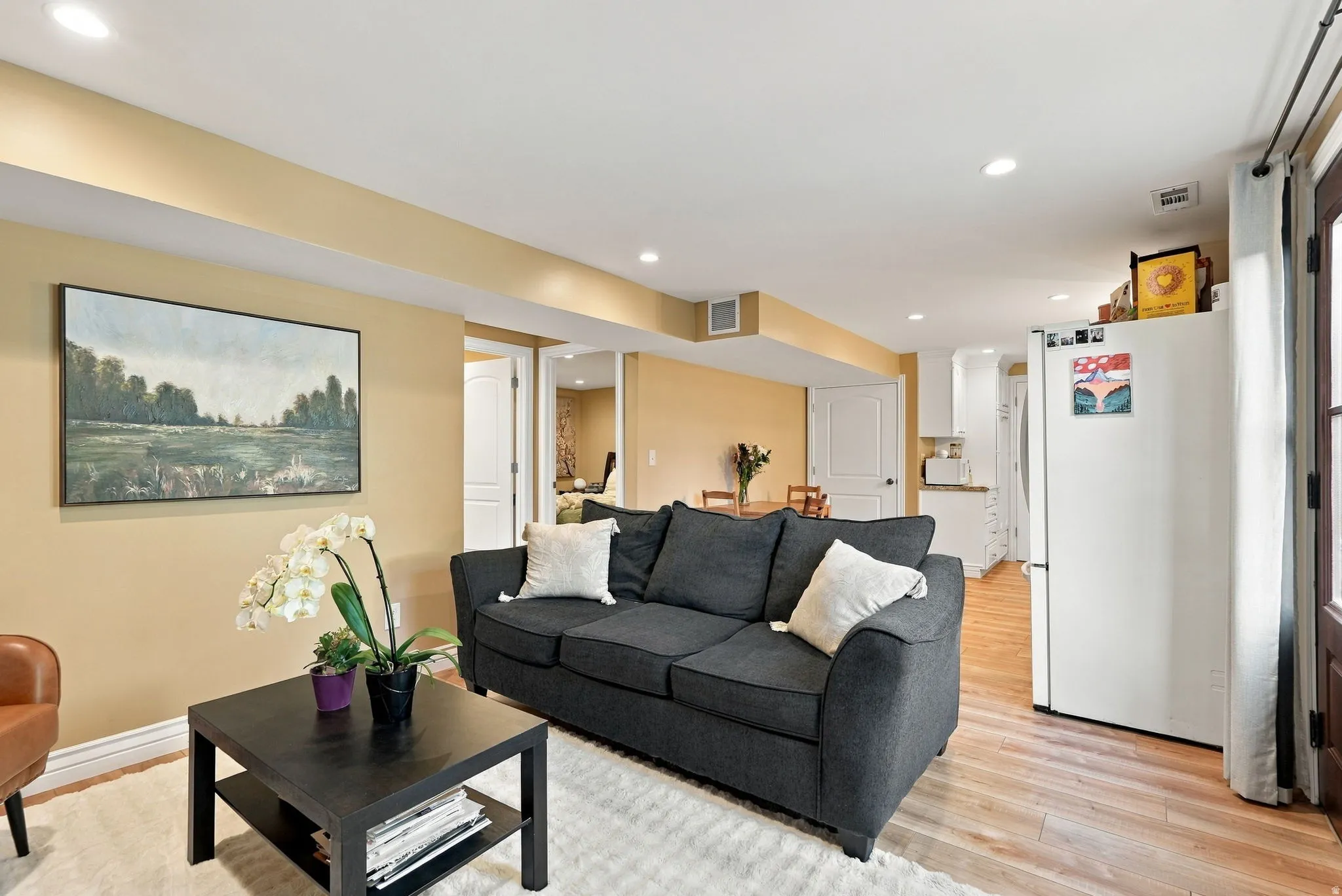 Recessed lighting, wood-finish flooring, white doors, and painted walls