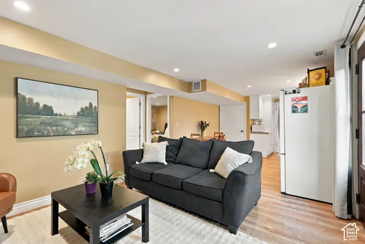 Recessed lighting, wood-finish flooring, white doors, and painted walls