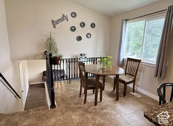 Tile flooring, light-toned wall paint, white window trim, and a built-in railing system