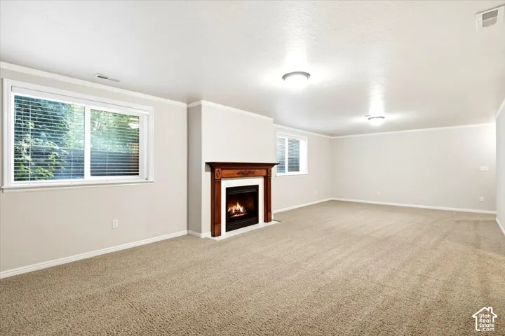 Living area with a wood-mantel fireplace, recessed lighting, and light-toned carpeting