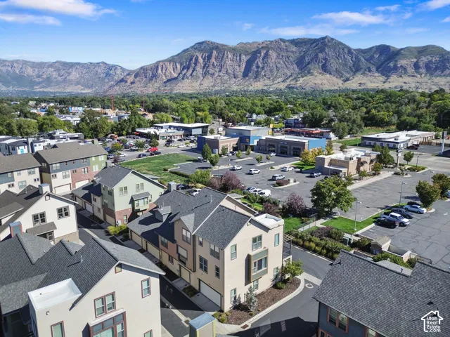 Modern townhomes with varied exterior finishes, attached garages, and pitched shingle roofs