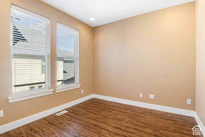 Wood-finish flooring with white trim and neutral wall tones