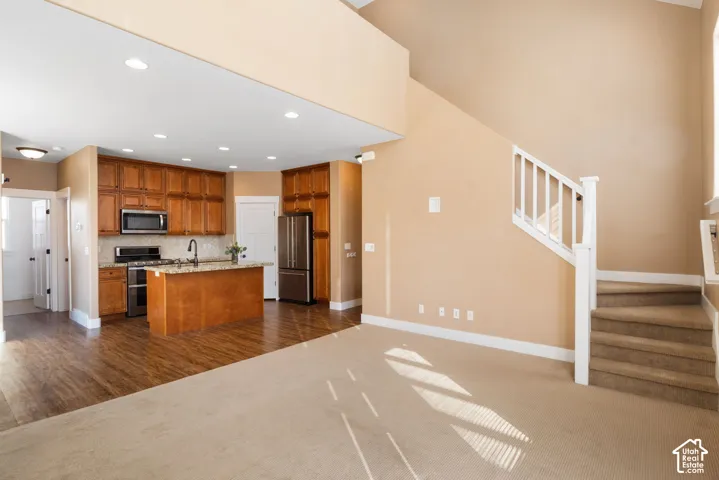Kitchen featuring wood cabinetry, stainless steel appliances, and a central island