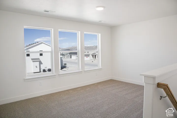 Large family room/loft area at top of stairs with great windows.