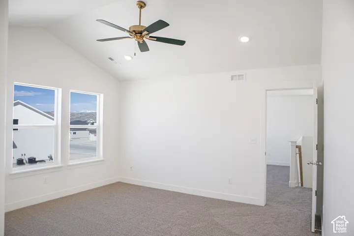 Primary bedroom with great windows, vaulted ceiling and ceiling fan.