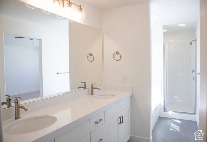 Primary bath with dual sinks, soaker tub and large walk-in shower with two shower heads.
