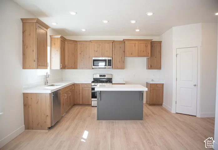 Terrific kitchen with 42" uppers, stained wood cabinets and painted wood island, quartz slab countertops, gas range, dishwasher, microwave and disposal.