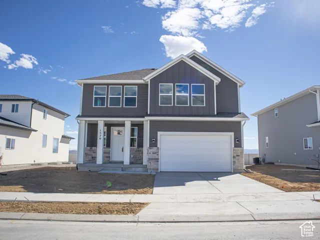 Spruce Elevation C with front yard landscaping installed since the photo was taken and decorative concrete wall on rear boundary.