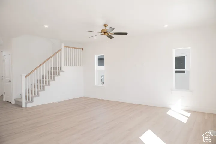 Family room with 9' ceiling and ceiling fan.