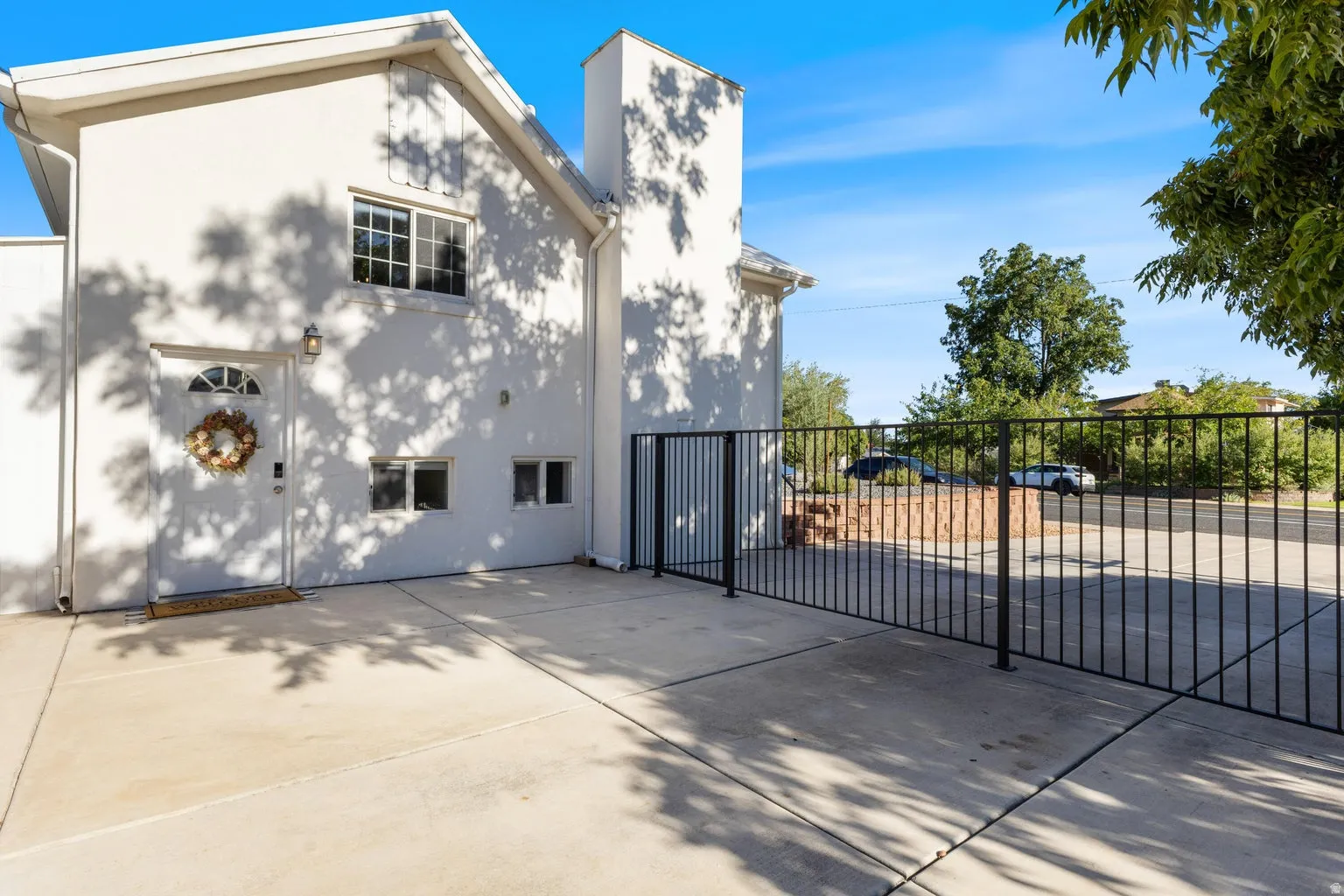 White stucco exterior with a prominent chimney structure