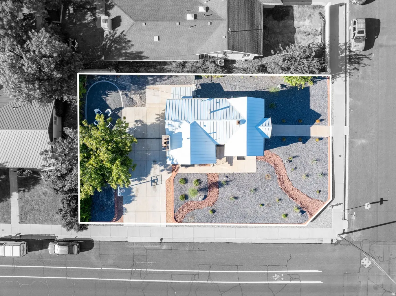 Modern single-story residence with a metal roof and a concrete driveway