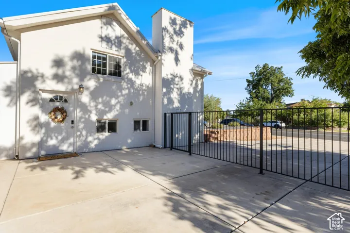 White stucco exterior with a prominent chimney structure