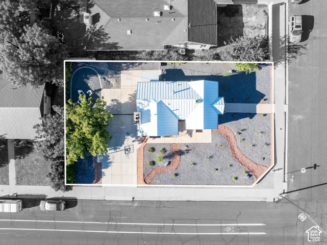 Modern single-story residence with a metal roof and a concrete driveway