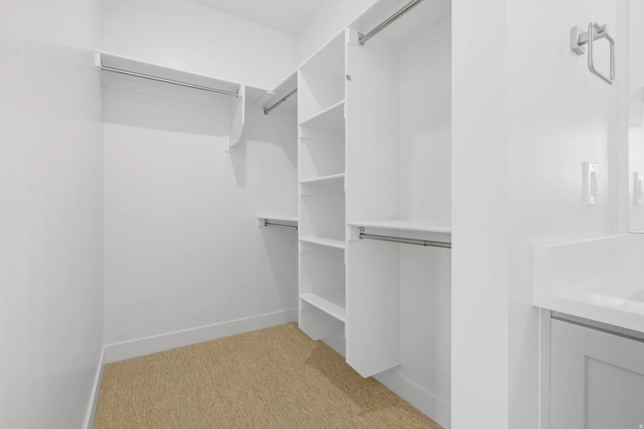 Walk-in closet with integrated shelving and hanging rods