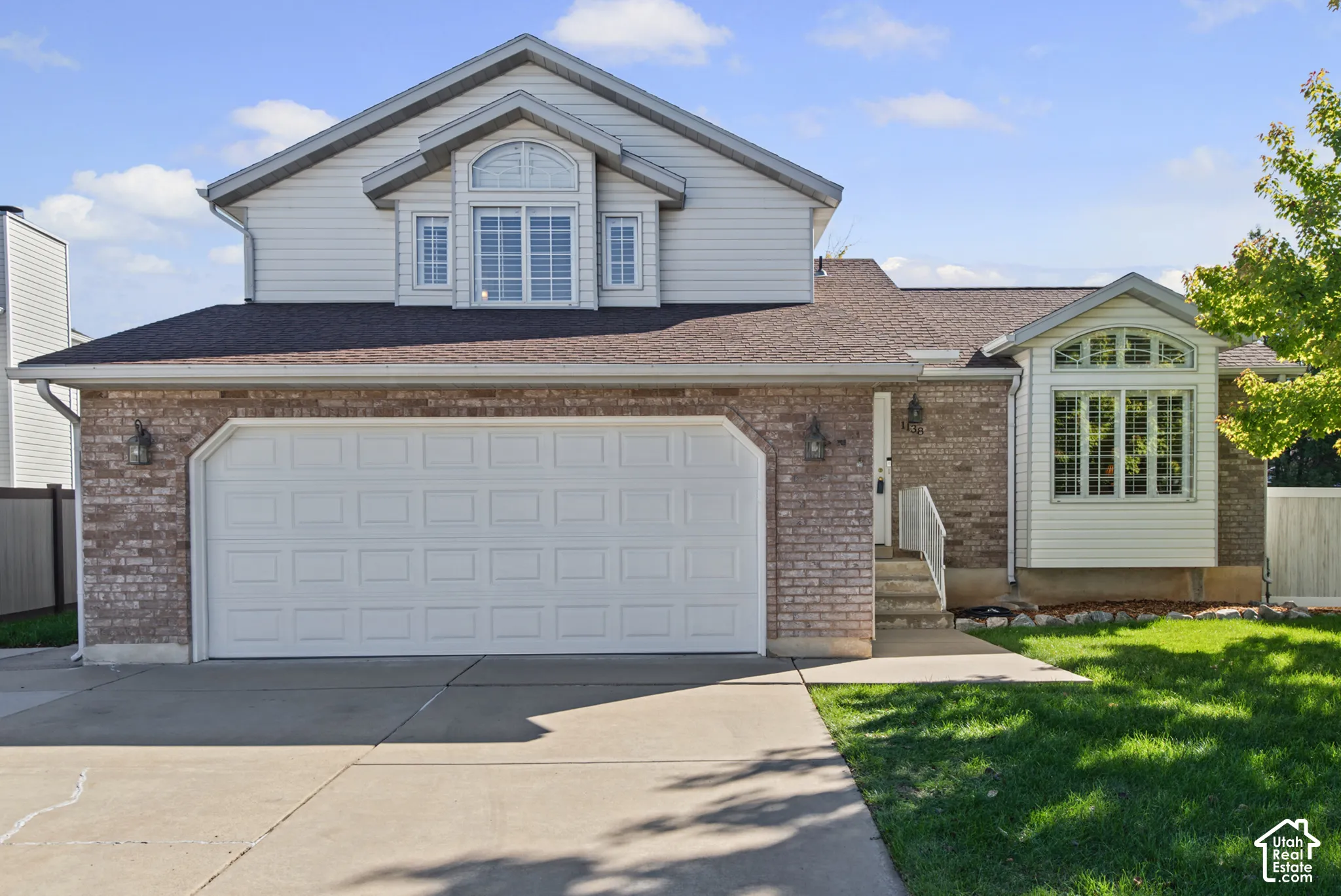 Brick and siding exterior with an attached two-car garage