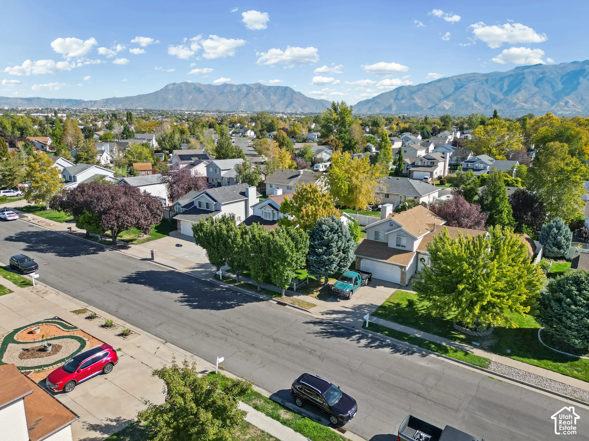 Neighborhood setting with mountain backdrop and mature trees