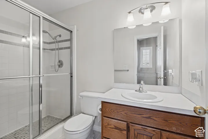 Glass-enclosed shower with white tile surround and accent banding