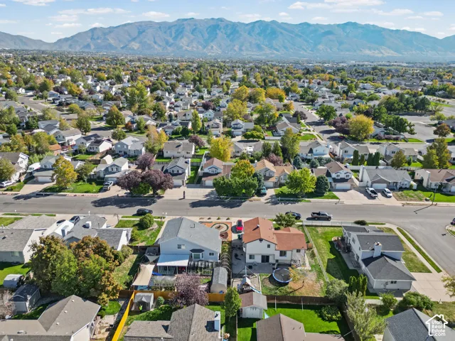 Residential neighborhood featuring mature trees and mountain scenery