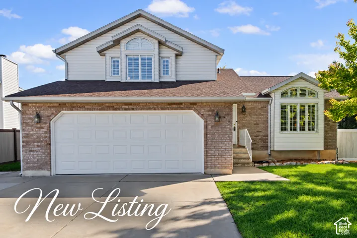 Brick and siding exterior with an attached two-car garage