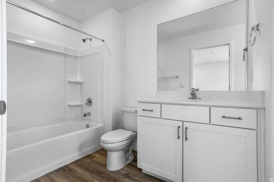 White vanity with integrated sink, coordinating countertop, and chrome faucet
