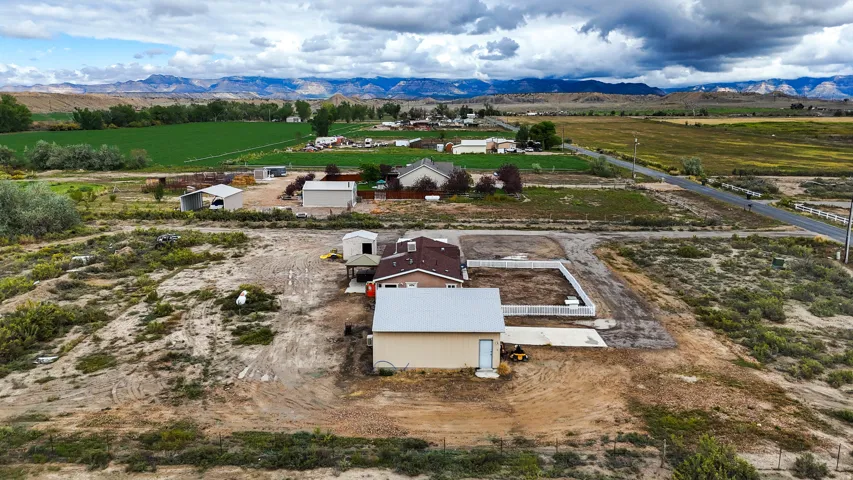 Expansive property featuring a main residence, detached garage, and additional outbuildings