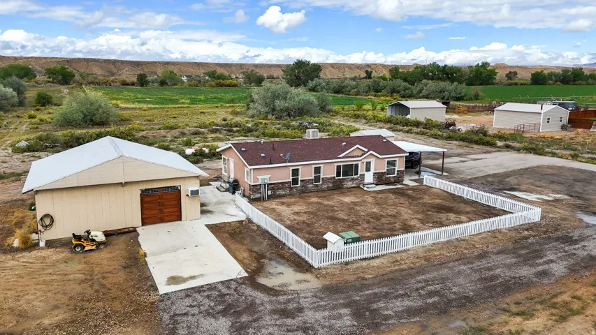 Single-story residence with a red shingle roof and partial stone facade