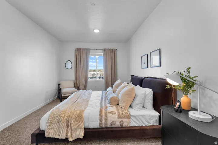 Recessed lighting, window with drapes, and carpeting