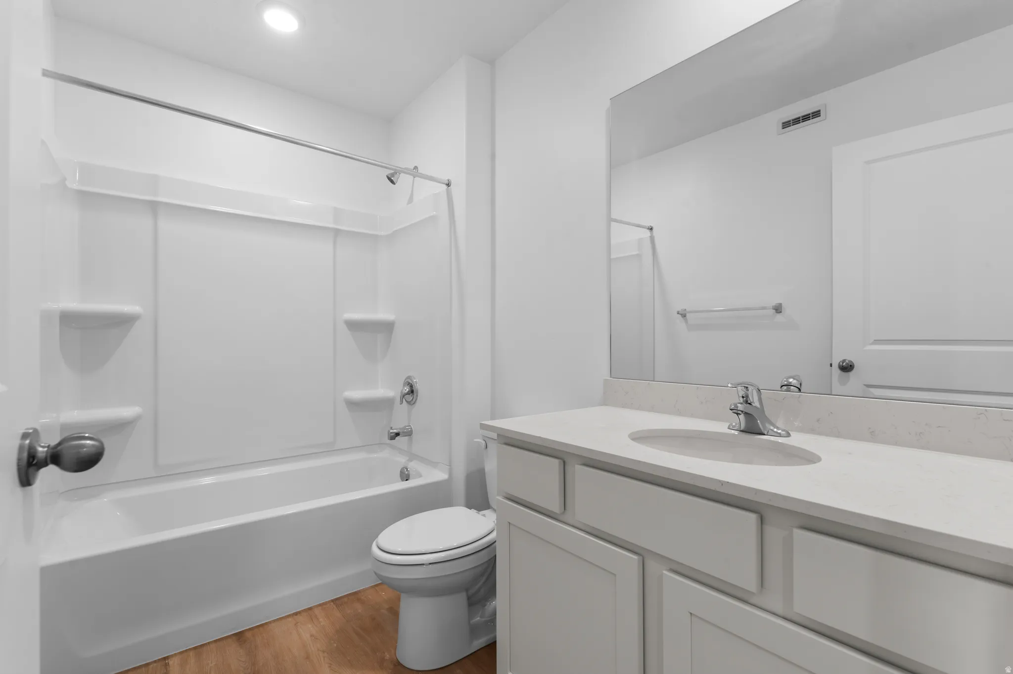 White vanity with an integrated sink and light-toned countertop