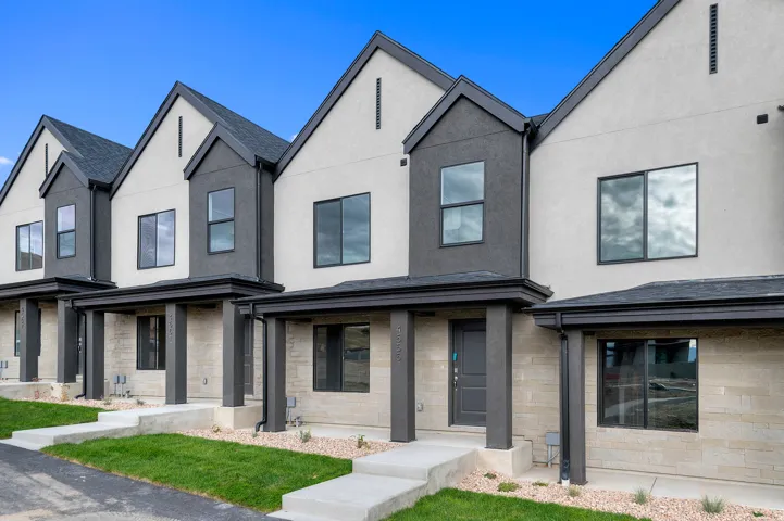 Modern facade with light stucco and dark accent panels