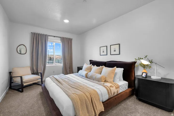 Carpeted flooring, recessed lighting, and a window with curtains