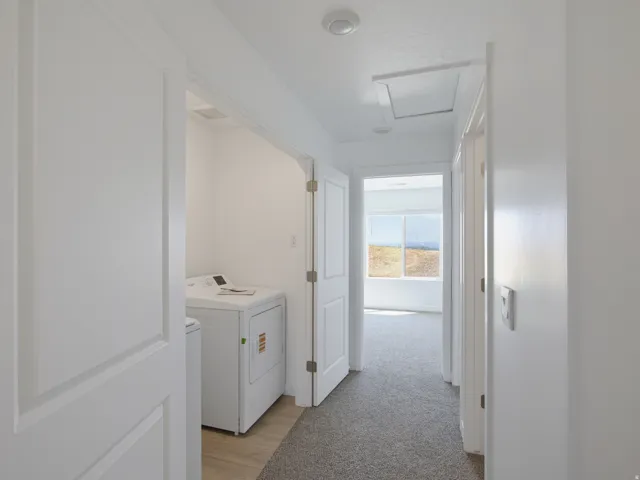 Laundry area with wood-finish flooring