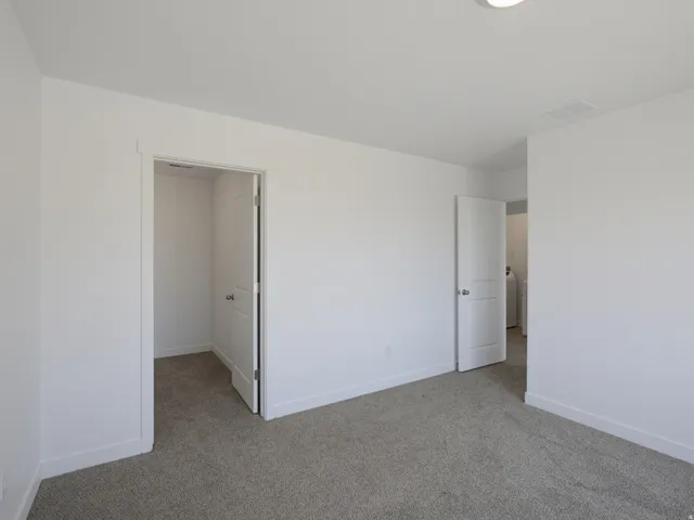 Neutral tone wall paint, textured carpet, solid core interior doors, flush mount ceiling lighting
