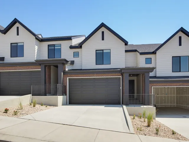 Modern multi-level exterior with white siding and dark trim accents