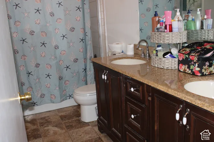 Dark wood-finish double vanity with dual undermount sinks and a light-colored countertop