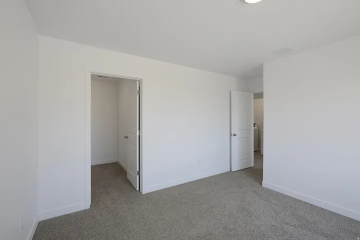 Carpet flooring, white painted walls, white trim, recessed lighting, and white interior doors