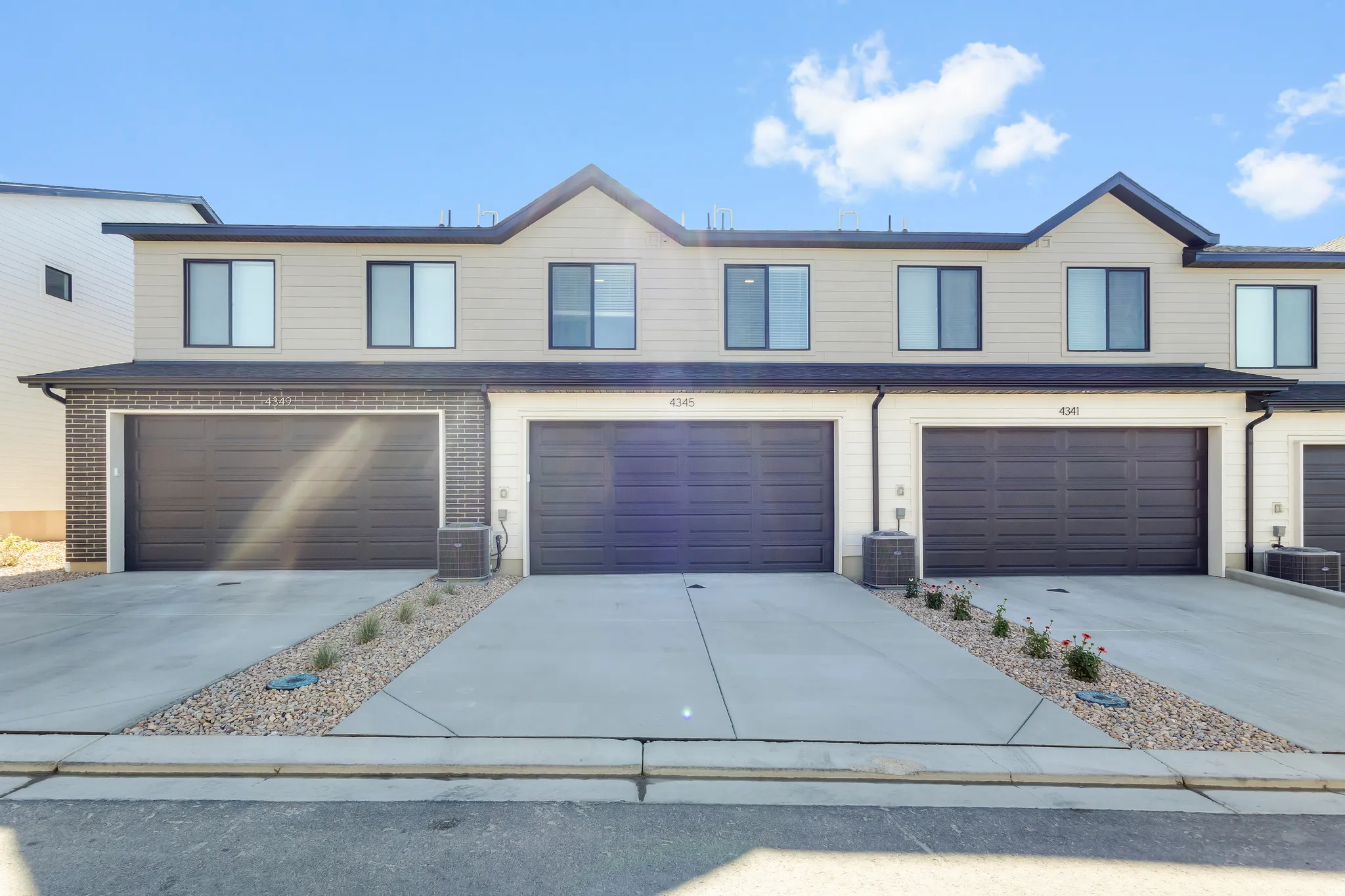 Modern townhome exterior with contrasting siding and brick accents